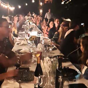 Paint of a woman diving into a swimming pool and a red F1 car in the background